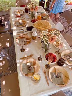 a long table with plates and cups on it