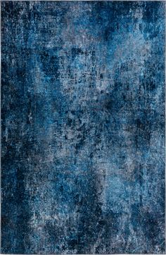 a blue rug with an abstract design on the top and bottom corner, in shades of gray