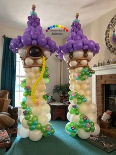 two tall balloon columns are decorated with balloons