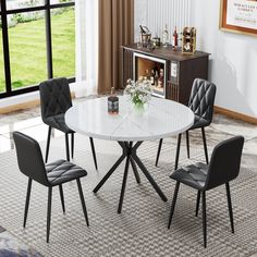 a white table with four chairs around it