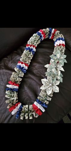 dollar bills are wrapped in red, white and blue ribbon to make a patriotic necklace