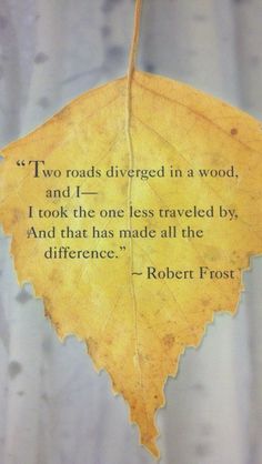 a leaf with a quote on it sitting in front of a blue background that says, two roads diver in a wood and i took the one less traveled by and that has made all