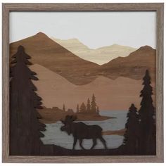 an image of a moose in the woods with mountains and water behind it, cut out from plywood