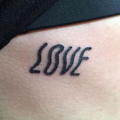 a woman's stomach with the word love written in cursive writing on it