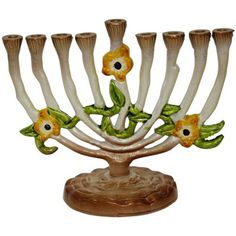 a ceramic menorah with flowers and leaves on it