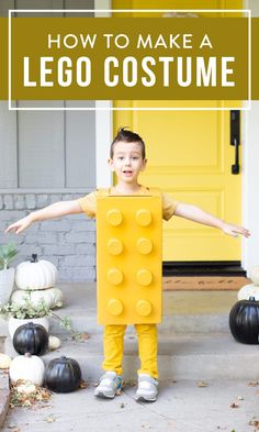 a young boy dressed up as a lego man standing in front of a yellow door