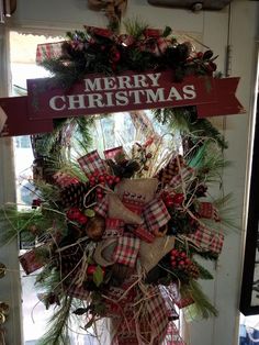 a christmas wreath hanging on the front door