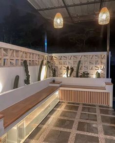 a wooden bench sitting on top of a tiled floor next to a white wall and ceiling