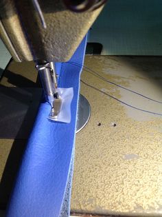 a close up of a sewing machine with fabric on the side and stitching tape