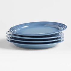 four blue plates stacked on top of each other