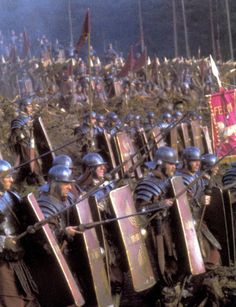 a large group of men in armor standing next to each other with swords and shields