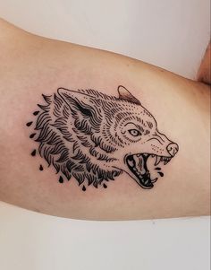 a black and white tattoo of a wolf's head