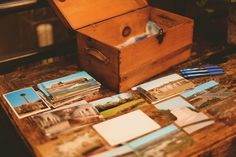 several photos are placed on a table with a wooden box