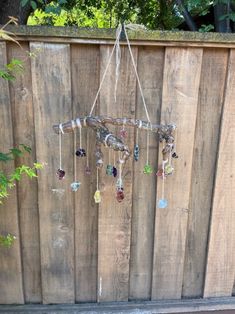 a wind chime hanging from a wooden fence