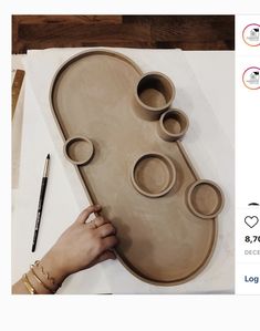 a person is making an art project out of clay