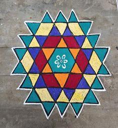 a colorful design on the ground that looks like a flower