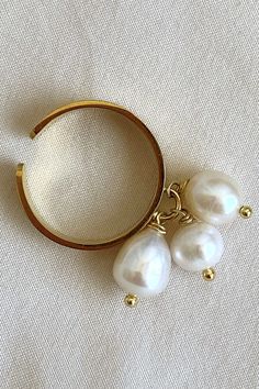 Adjustable Pearl ring, charm ring to my daughter. Old Money jewelry by MarinaMiJewelry. Freshwater pearls cocktail ring, trendy jewelry. This ring features three freshwater pearls delicately hanging and gracefully swaying with the movement of your hand. The enchanting pearls add a touch of elegance and sophistication, making this ring a charming accessory that catches the eye with its graceful dance. Pearl Drop Open Ring Jewelry, Adjustable Pearl White Ring With Pearl Drop, Pearl Drop Open Ring, Elegant Pearl Chain Ring, Adjustable Pearl White Ring With Pearl Charm, Gift Pearl Ring With Pearl Charm, Pearl Ring With Pearl Charm As Gift, Elegant Adjustable Pearl Ring With Charm, Adjustable Elegant Pearl Drop Ring