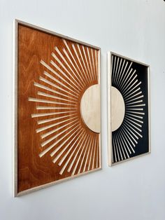 two art pieces are hanging on the wall next to each other, one is made out of wood