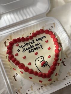 a heart shaped cake with writing on it