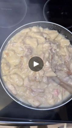 a pan filled with food cooking on top of an electric stove next to two burners