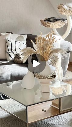 a living room filled with furniture and lots of pillows on top of a coffee table