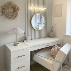 a white desk with a mirror and chair