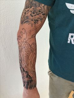 a man with a dragon tattoo on his arm