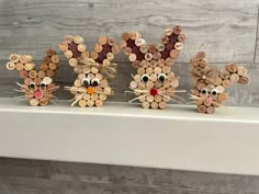 three wooden mice made to look like they are sitting next to each other on a mantle