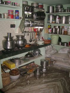 the kitchen is cluttered with pots and pans