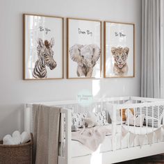 a baby's room with three animal prints on the wall