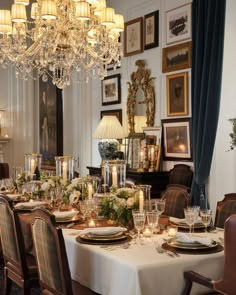 a dining room table is set with candles and place settings