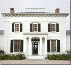 a large white house with black shutters