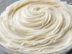 a bowl filled with white frosting on top of a table