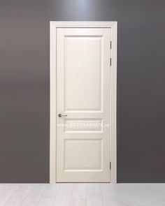 an empty room with a white door and grey walls