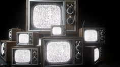 five old tvs are stacked on top of each other in different sizes and shapes