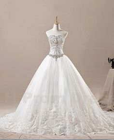 a white wedding dress on a mannequin with beading and sequins