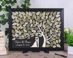 a couple under a tree with their wedding date on it, next to some books