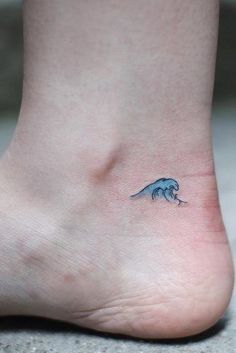 a small blue wave tattoo on the left side of the foot is shown in this image