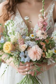 a woman holding a bouquet of flowers in her hands