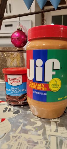 jars of peanut butter and jelly sit on a table