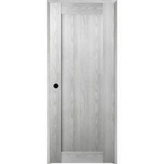 a white door with black knobs on the front and side paneled in wood