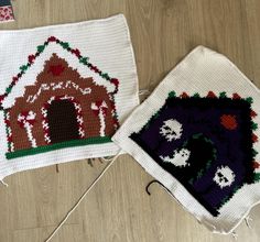 two crocheted houses are on the floor next to each other