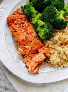 salmon, rice and broccoli on a white plate