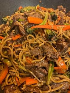 beef and vegetable stir fry in a wok