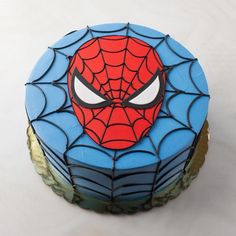 a spiderman cake on a white table