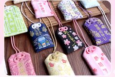 many small bags are lined up on a table with bamboo mat and pink flowers in the background