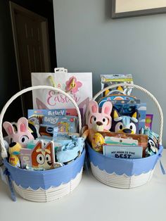 two baskets filled with toys sitting on top of a white counter next to each other