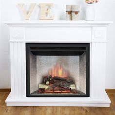 a white fireplace with wood logs and letters on the mantel above it that says love