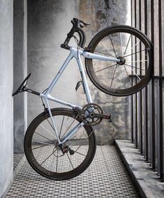 a bike is hanging from the side of a building