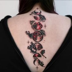 the back of a woman's neck with tattoos on it and phases in different colors